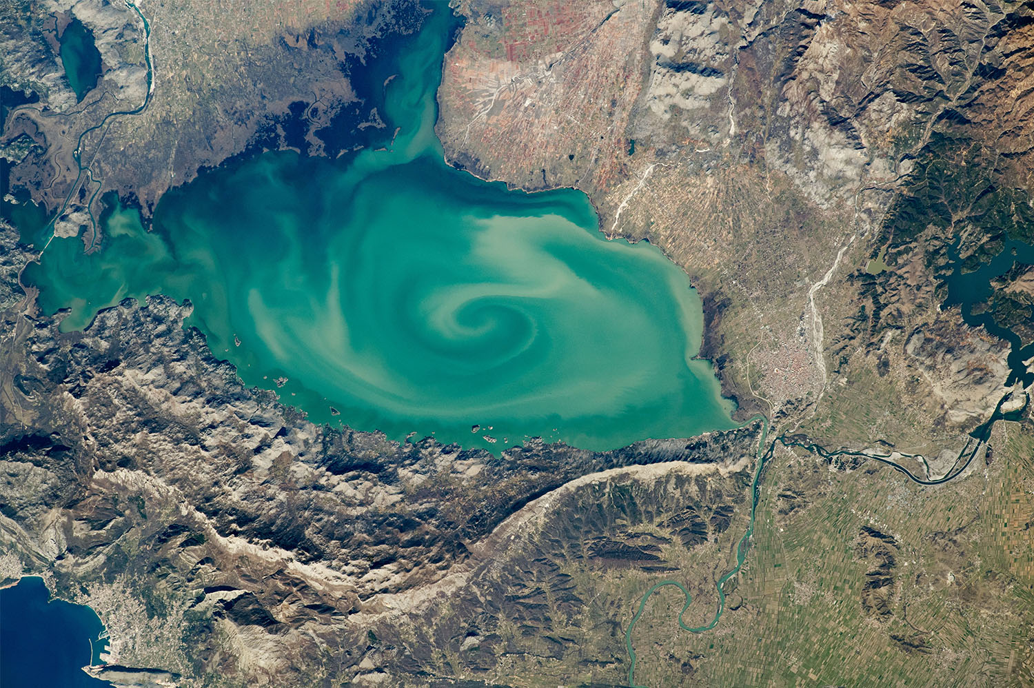 Lake Skadar. The largest lake on the Balkan Peninsula is colored by sediments eroded from the surrounding highlands. Credit: NASA.