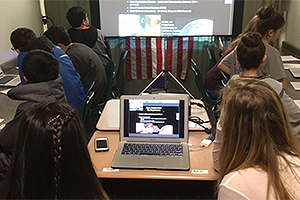 Picture of students in a classroom watching a NASA Webinar on their laptop computers. Credit: NASA.