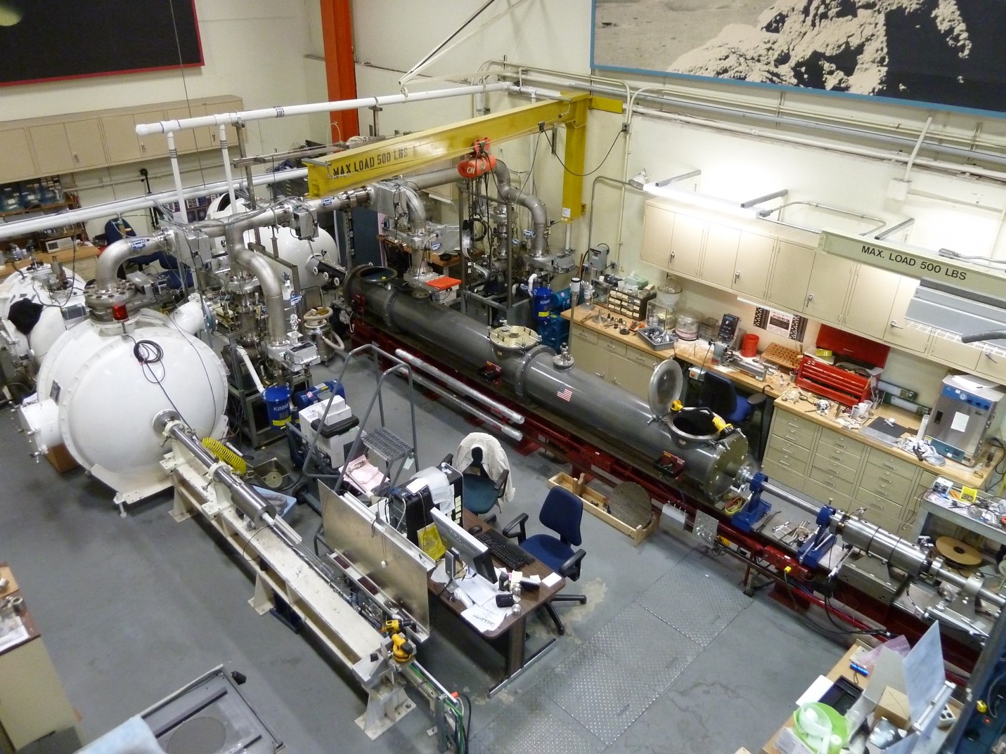 Inside the Experimental Impact Laboratory: Photograph of the EIL taken from the mezzanine floor that shows the flat-plate accelerator on the left and the light-gas gun on the right.