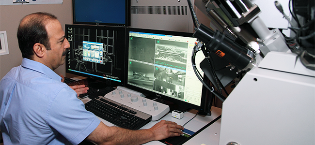 Inside the Focused Ion Beam Laboratory: NASA scientist Zia Rahman (pictured) 
					behind the controls of the Quanta 3D FEG, one of the most sensitive electron microscopy 
					systems for 2D and 3D analysis and characterization of astromaterials.