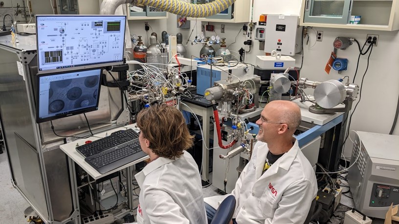 Inside the Light Element Analysis Laboratory: NASA scientists Justin Hayles and Paul Niles fluorinate sample for oxygen isotope analysis with a Thermo Electron gas chromatograph-mass spectrometer (GC-MS).