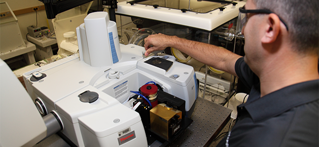 Inside the Spectroscopy and Magnetics Laboratory: NASA scientists use a Fourier 
					Transmission Infrared Spectrometer (pictured) to analyze terrestrial analogs in support 
					of the Mars rover missions.