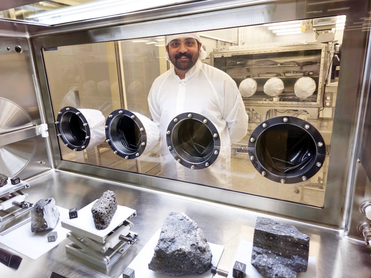 Lunar Processor Lokin Casturi looking through the Apollo sample display cabinet